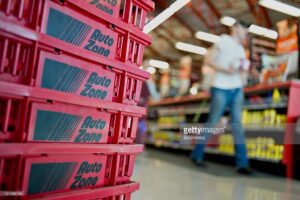 Stack of red Auto Zone shopping baskets.