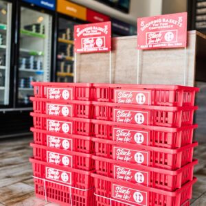 Stack of red shopping baskets.