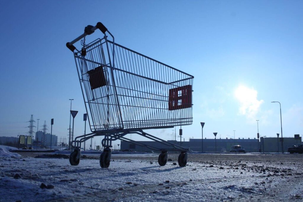 Shopping cart in parking lot in the winter.