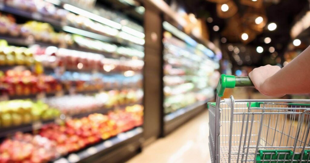 Shopping cart in produce aisle.