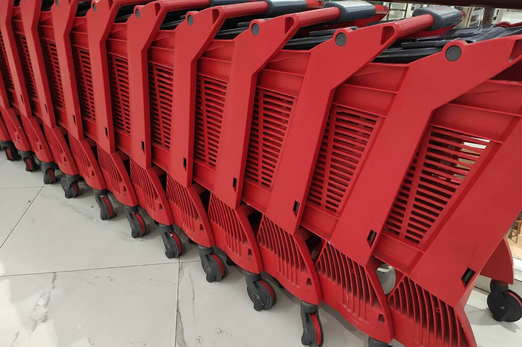 A row of red plastic shopping carts.