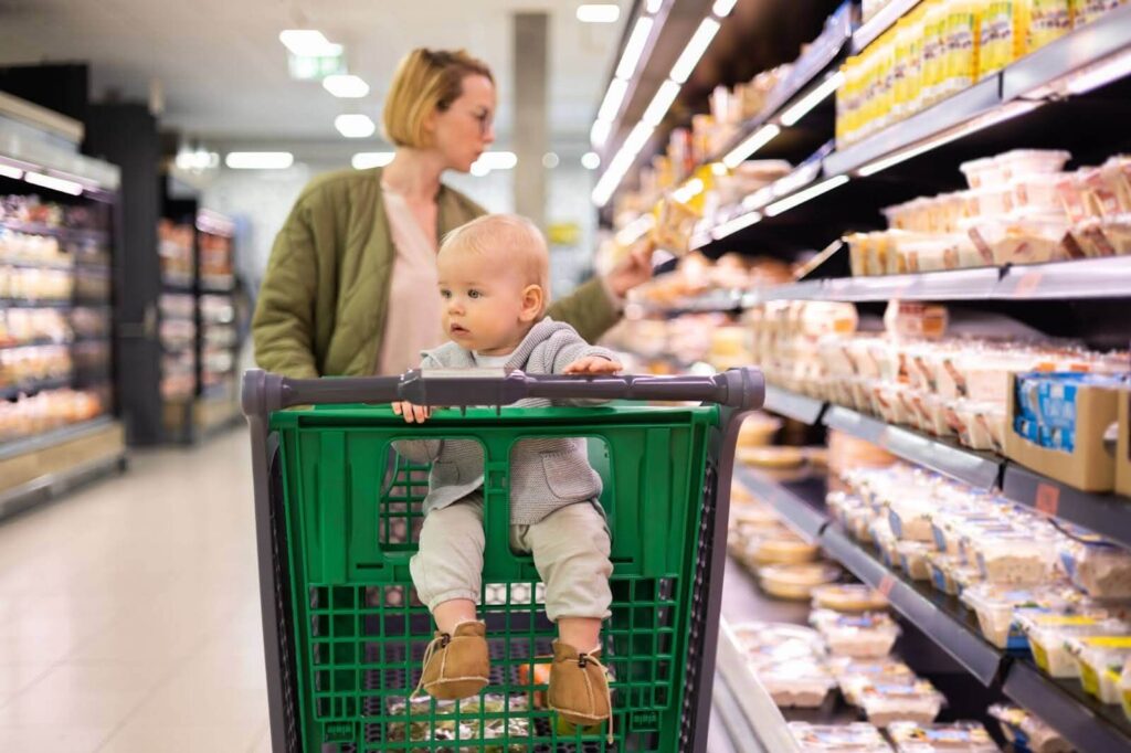 Little boy in a child-friendly shopping cart.