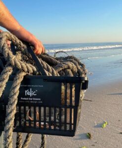 Black shopping basket with rope in it.