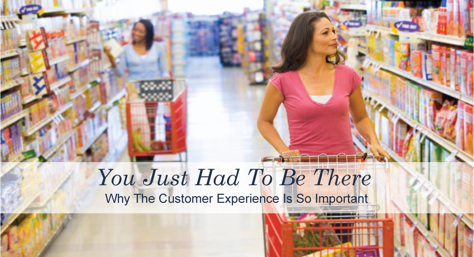 Two women shopping for groceries in a supermarket aisle filled with products.