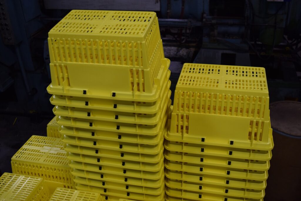 A stack of yellow handheld shopping baskets.