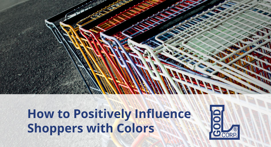 A row of different colored metal shopping carts.